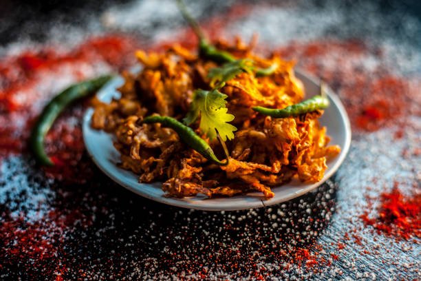 Crisp onion pakoda in a paper cone